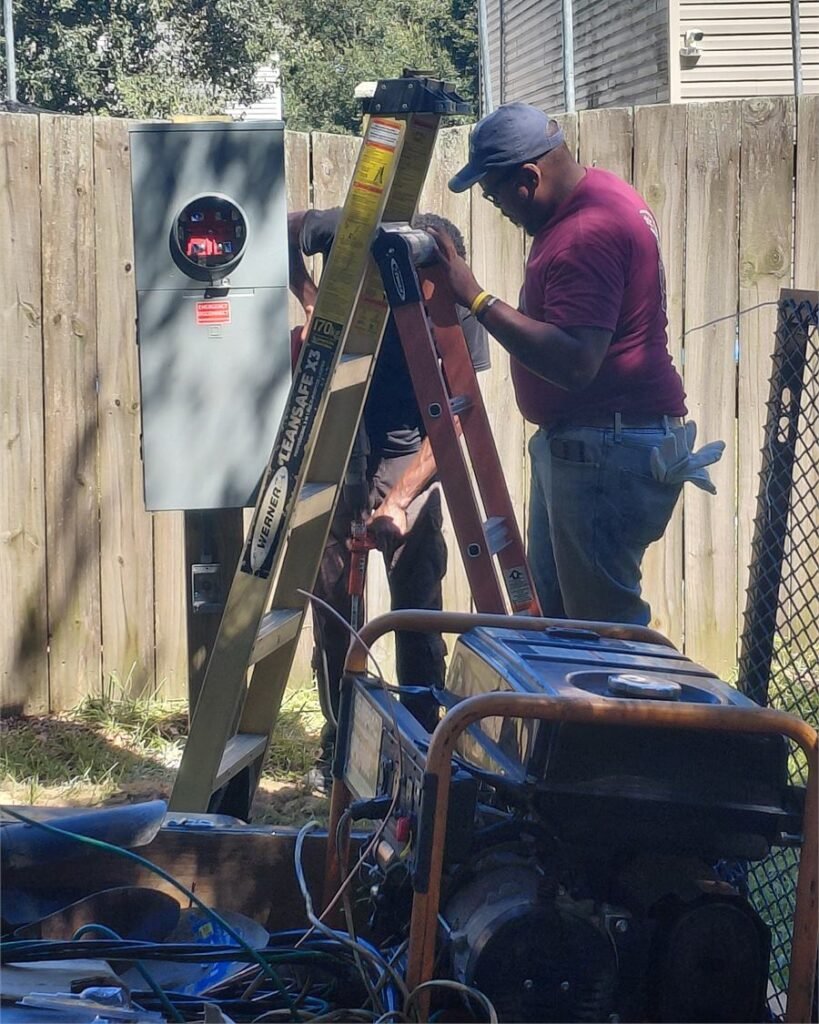 Two Palmetto Electric electricians working on residential service equipment