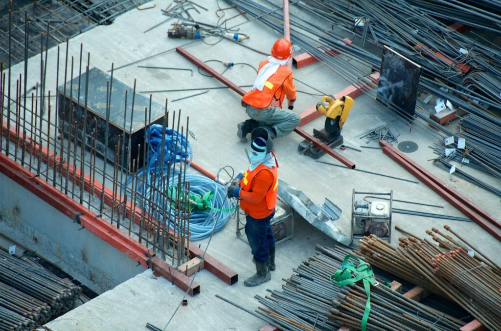 Construction workers in hard hats and safety vests on a job site