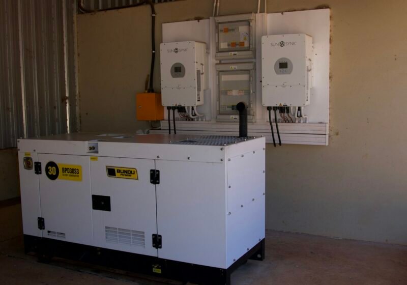 Standby generator installed beside wall-mounted electrical equipment